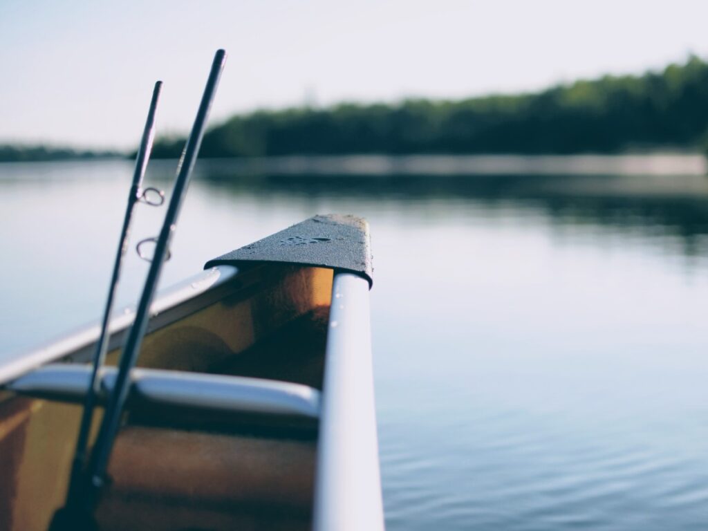 canoe with fishing rods on a lake
