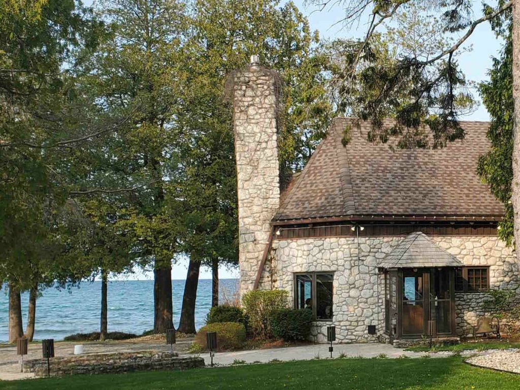 Grey stone building in front of Lake Michigan. Donny's Glidden Lodge Restaurant