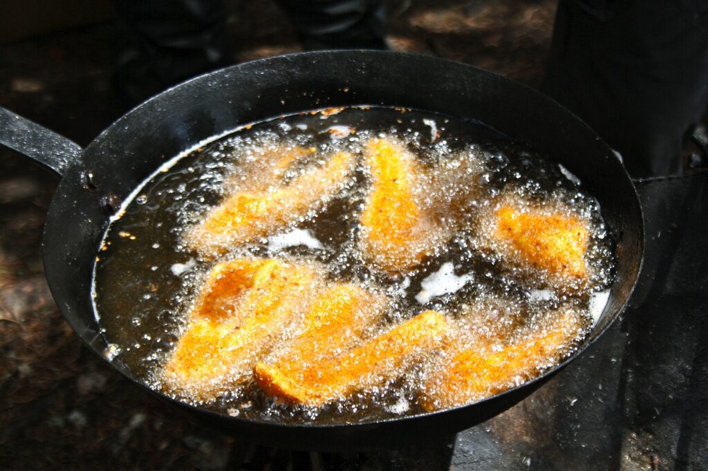 walleye fillets being friend in a pan