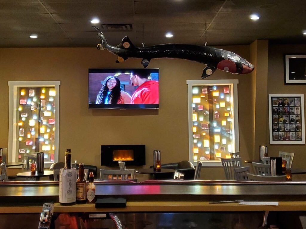 Bar, fiberglass decorative sturgeon, stained class, pictures of veterans at the Nightingale