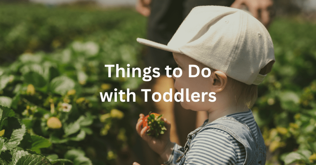 photo of a toddler holding a strawberry. Superimposed text says: Things to Do with Toddlers