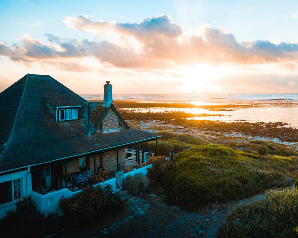 house on the coast with a sunrise or sunset