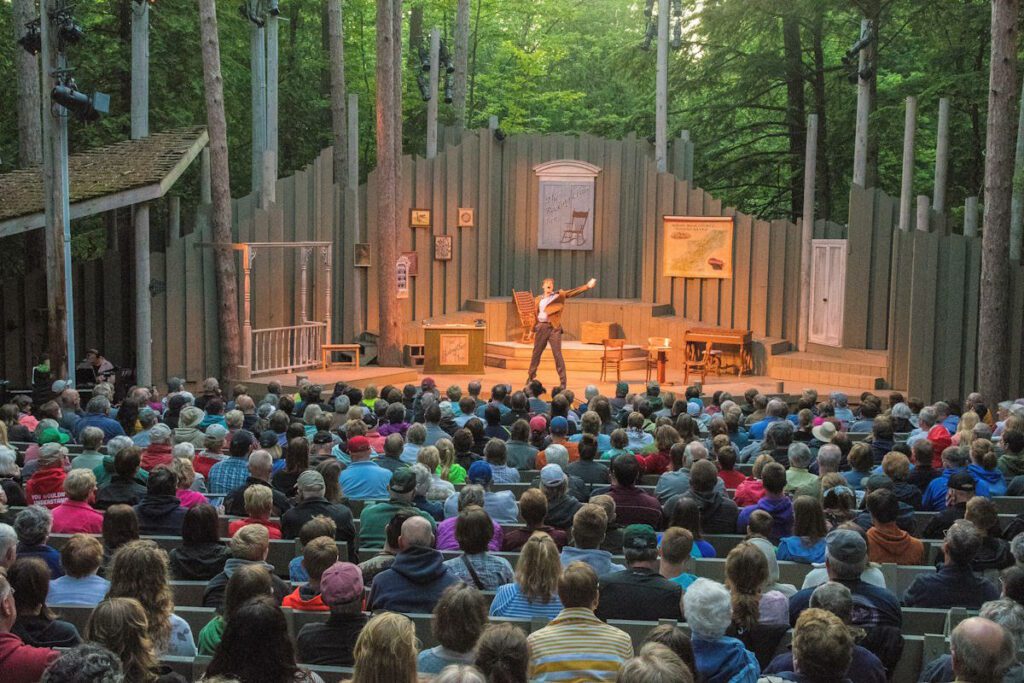 Theater goers watching a performance of Northern Sky Theater in Peninsula State Park.