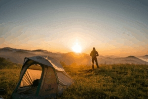 man standing outside of tent